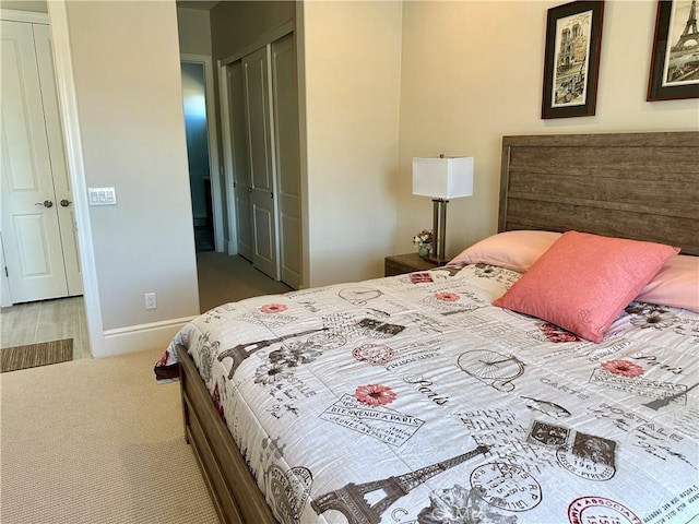 bedroom featuring a closet, baseboards, and carpet