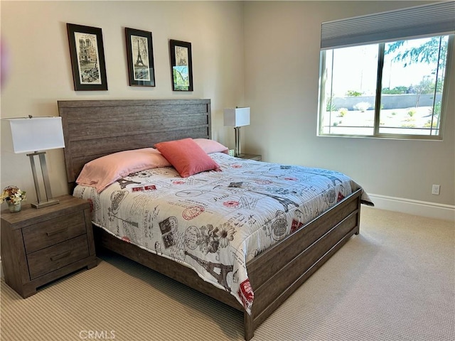 bedroom with baseboards and carpet floors