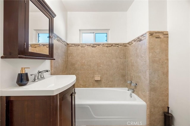 bathroom with a washtub and vanity