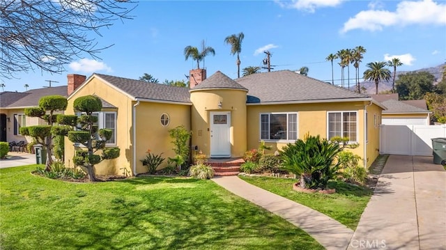 view of front of property with stucco siding, a front lawn, a gate, fence, and a chimney