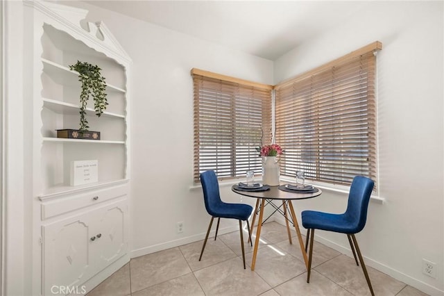 dining room featuring light tile patterned floors and baseboards