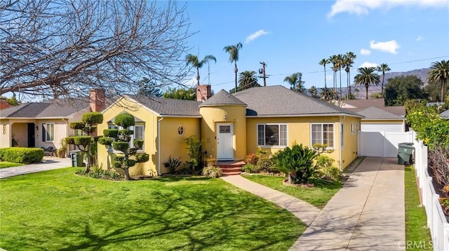 view of front of property featuring a front yard, a gate, fence, a chimney, and stucco siding