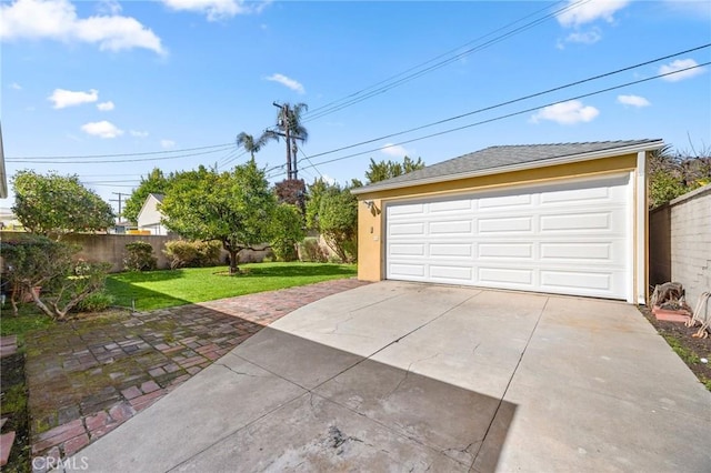 detached garage featuring fence