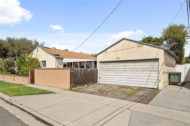 detached garage featuring a gate and fence