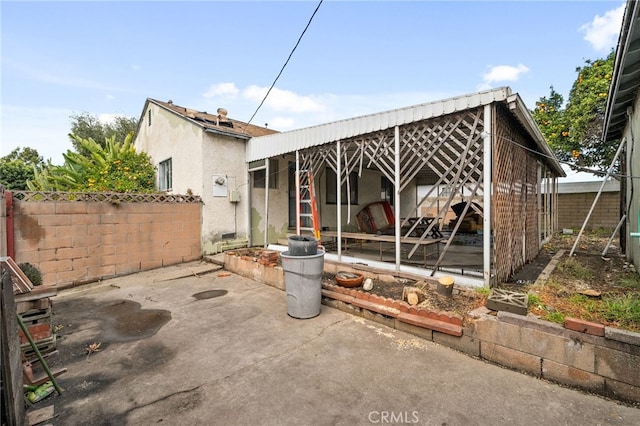 back of house with stucco siding, a patio, and a fenced backyard