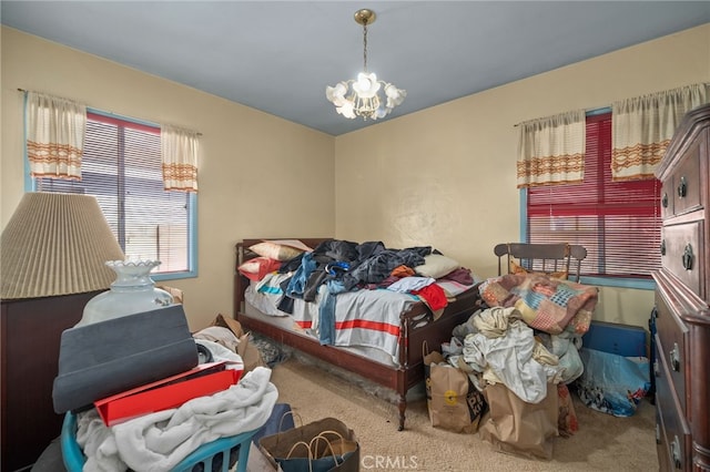 bedroom featuring an inviting chandelier and carpet flooring