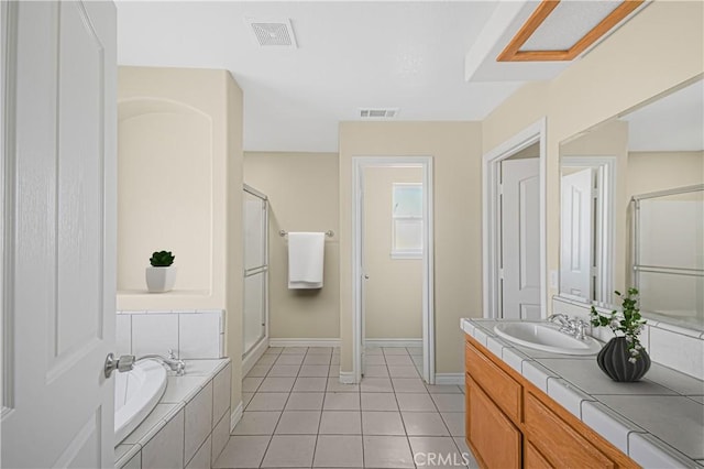 bathroom with tile patterned flooring, visible vents, a stall shower, and a garden tub