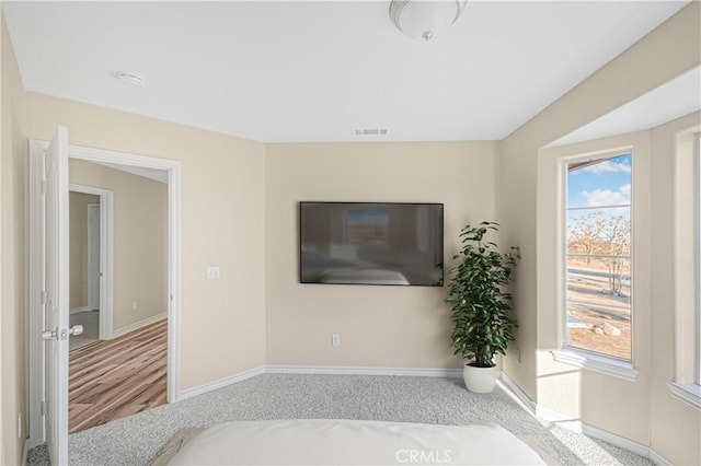 bedroom featuring visible vents and baseboards