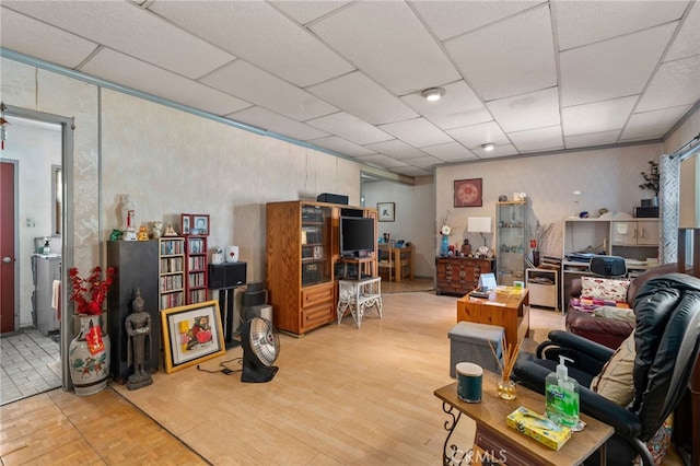 interior space featuring a paneled ceiling and wood finished floors