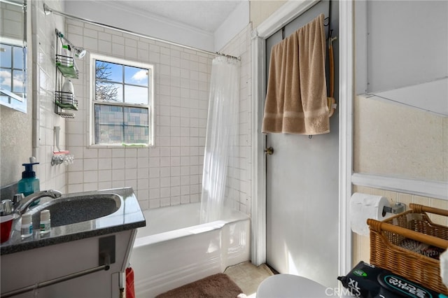 full bath featuring vanity, crown molding, and shower / bath combo with shower curtain