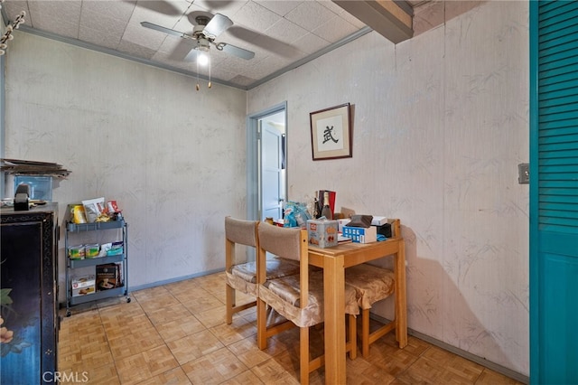 dining space featuring baseboards and a ceiling fan