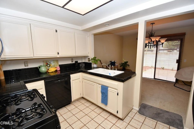 kitchen with black appliances, a sink, white cabinetry, light tile patterned flooring, and tile counters