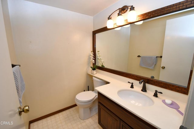 bathroom with vanity, tile patterned floors, toilet, and baseboards