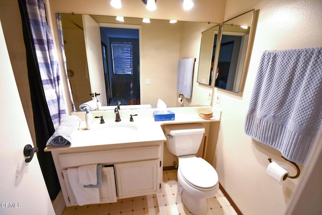 bathroom with toilet and vanity