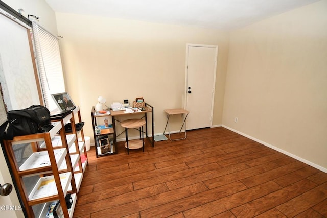 office area with hardwood / wood-style flooring and baseboards