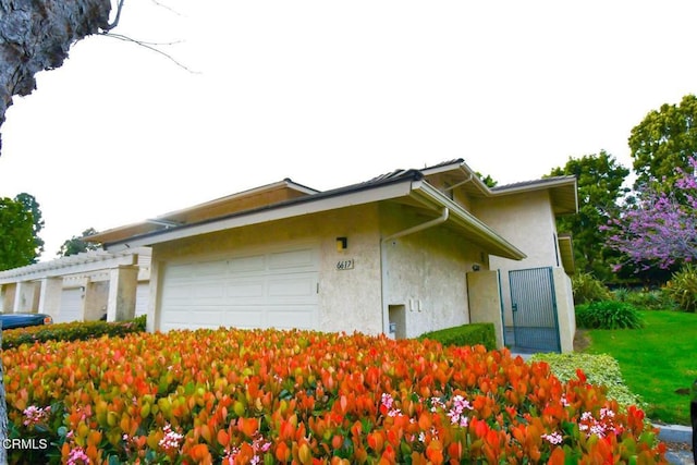 view of home's exterior with stucco siding and an attached garage