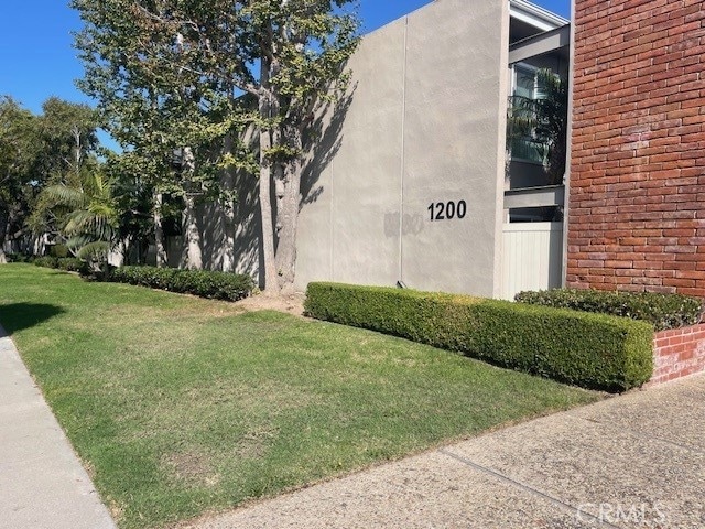 view of side of property with a lawn