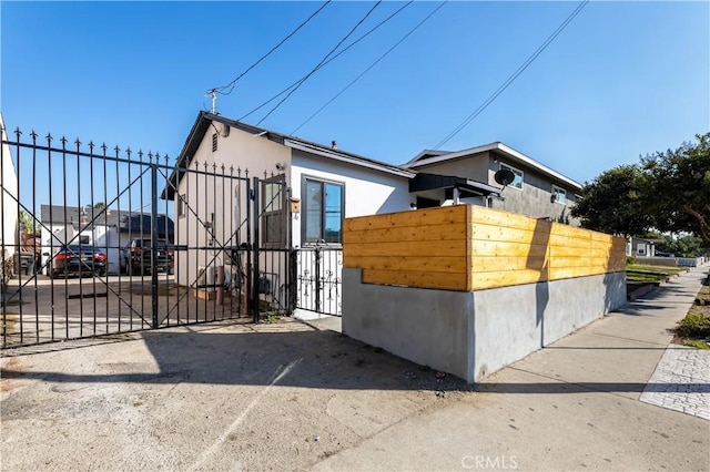 view of side of home with a gate and fence