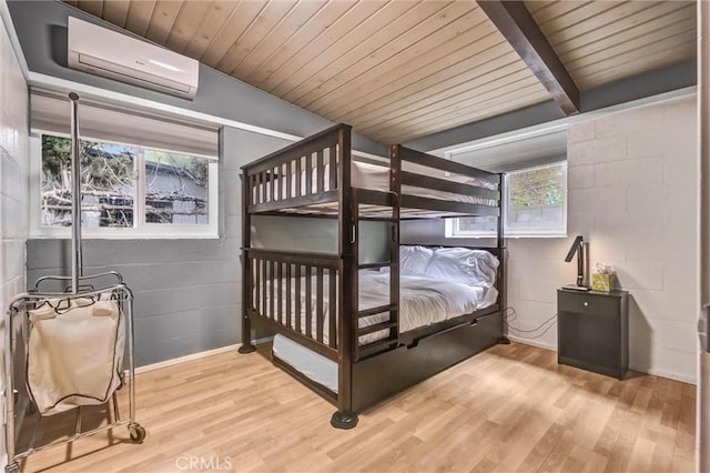 bedroom featuring an AC wall unit, beam ceiling, wooden ceiling, wood finished floors, and concrete block wall