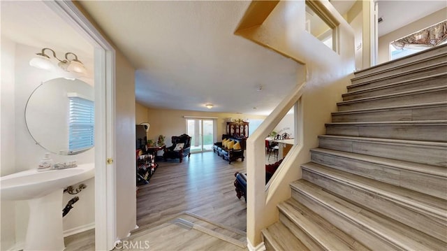 staircase with wood finished floors