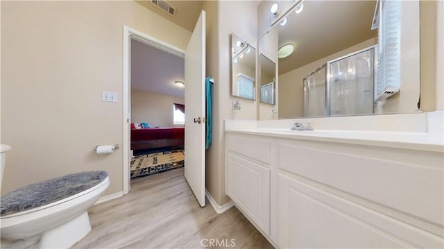 full bath featuring visible vents, toilet, a stall shower, wood finished floors, and ensuite bath