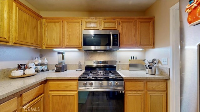 kitchen featuring stainless steel appliances and light countertops