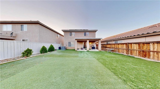 rear view of house featuring stucco siding and a fenced backyard