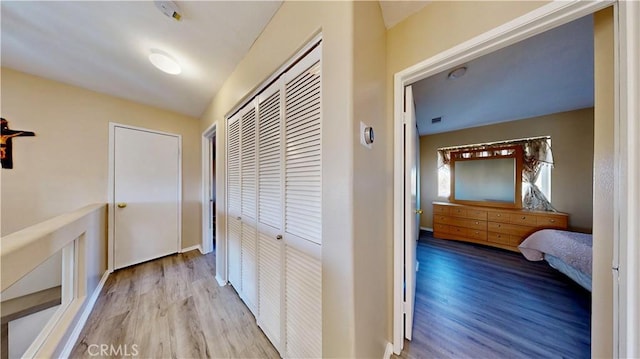 hall featuring baseboards and wood finished floors