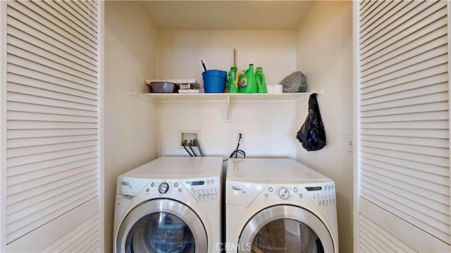 laundry area with washer and clothes dryer and laundry area