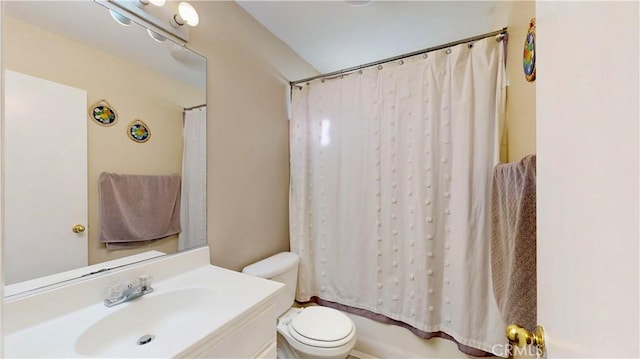 bathroom with shower / bathtub combination with curtain, toilet, and vanity