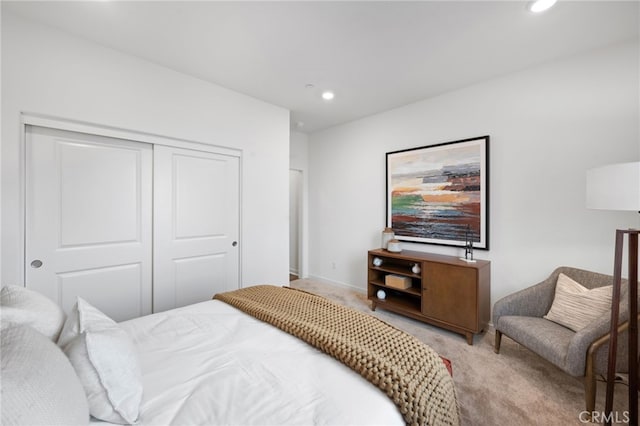 bedroom featuring a closet, recessed lighting, baseboards, and carpet