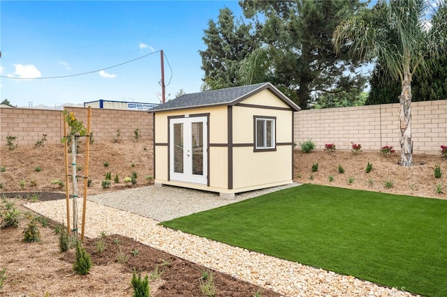 view of outdoor structure featuring an outbuilding and a fenced backyard