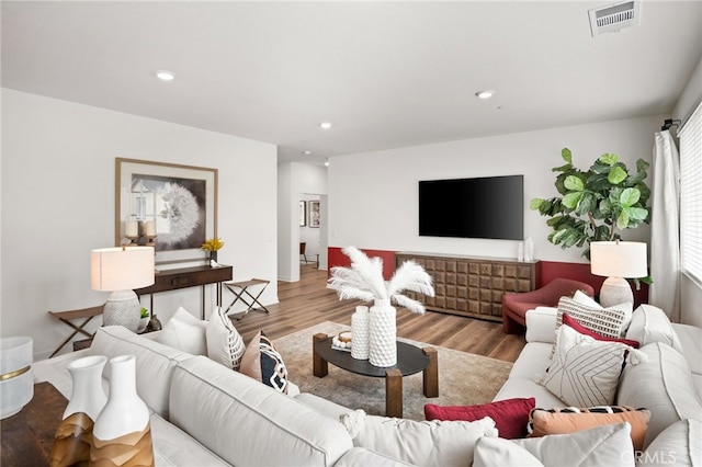 living area featuring visible vents, recessed lighting, and light wood-style floors