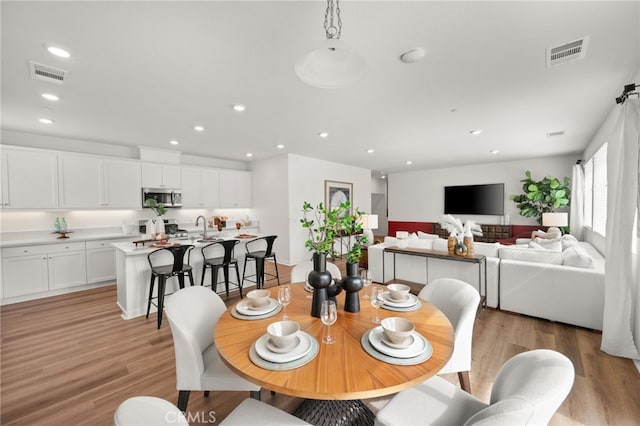 dining area featuring recessed lighting, visible vents, and light wood-style flooring