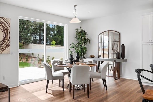 dining room with light wood-style flooring and baseboards