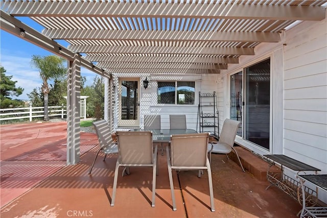 view of patio with outdoor dining area, a pergola, and fence