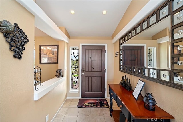 foyer entrance featuring tile patterned flooring, recessed lighting, baseboards, and lofted ceiling