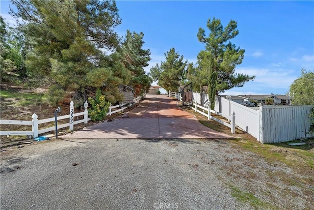 view of road with a gated entry and driveway