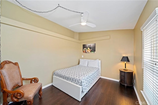 bedroom with ceiling fan, baseboards, and wood finished floors