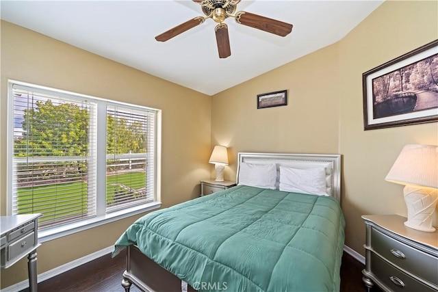 bedroom with baseboards, dark wood-type flooring, ceiling fan, and vaulted ceiling