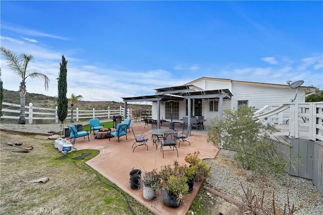 back of house featuring a patio area, a fire pit, and fence