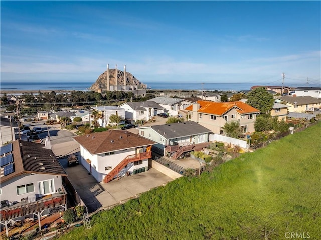 drone / aerial view featuring a residential view and a water view