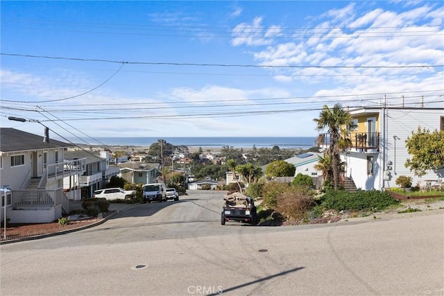 view of street featuring curbs and stairway