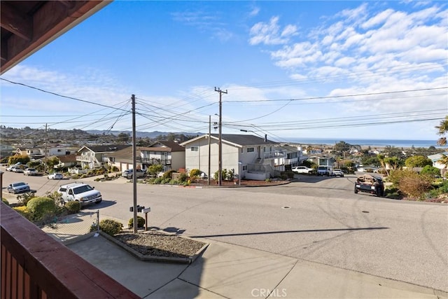 view of road featuring curbs and a residential view