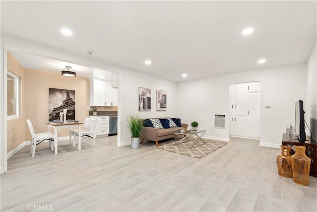 living room with recessed lighting, light wood-type flooring, and baseboards