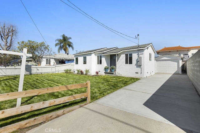11541 Basye St, El Monte, CA 91732 - view of front of house featuring fence, concrete driveway, a front yard, a garage, and an outbuilding