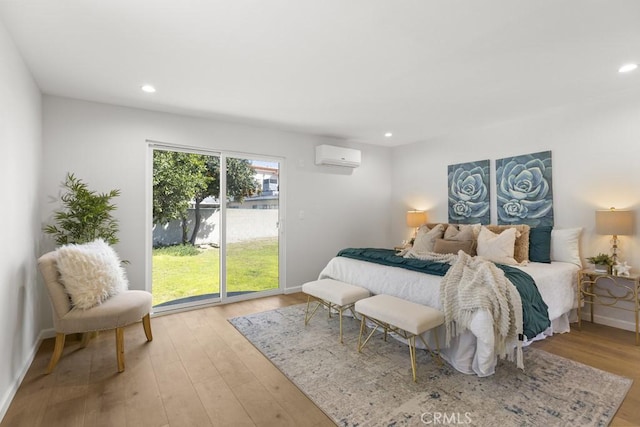 11541 Basye St, El Monte, CA 91732 - bedroom with light wood finished floors, recessed lighting, a wall mounted air conditioner, and baseboards