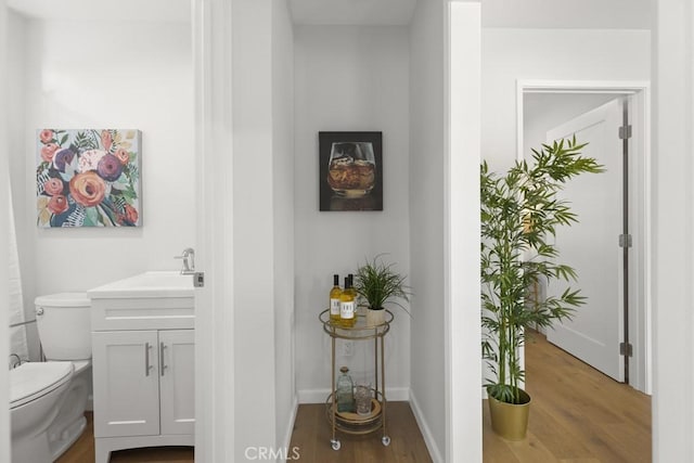 11541 Basye St, El Monte, CA 91732 - corridor featuring a sink, baseboards, and wood finished floors