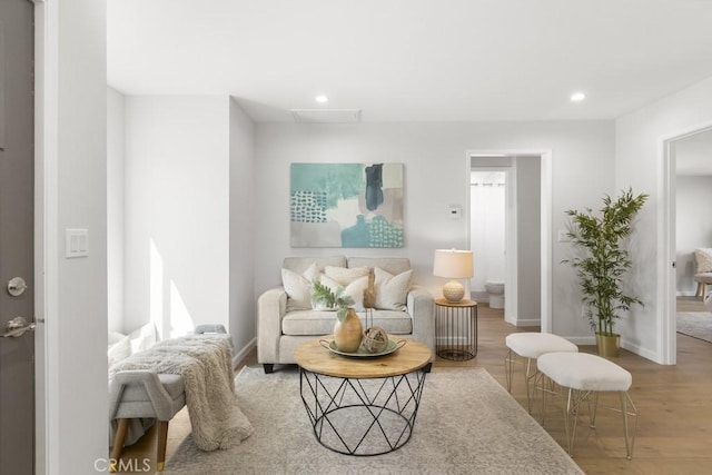 living area with recessed lighting, wood finished floors, and baseboards