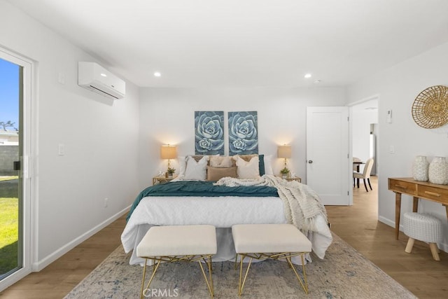 11541 Basye St, El Monte, CA 91732 - bedroom featuring multiple windows, a wall mounted AC, recessed lighting, light wood-style floors, and baseboards